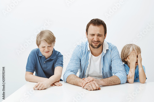 Slika na platnu Father and sons feeling upset while mom at work