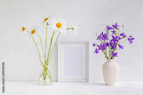 Mockup with a white frame and summer flowers