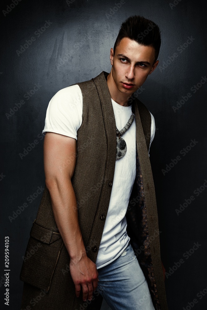 portrait of handsome stylish young man  posing in studio