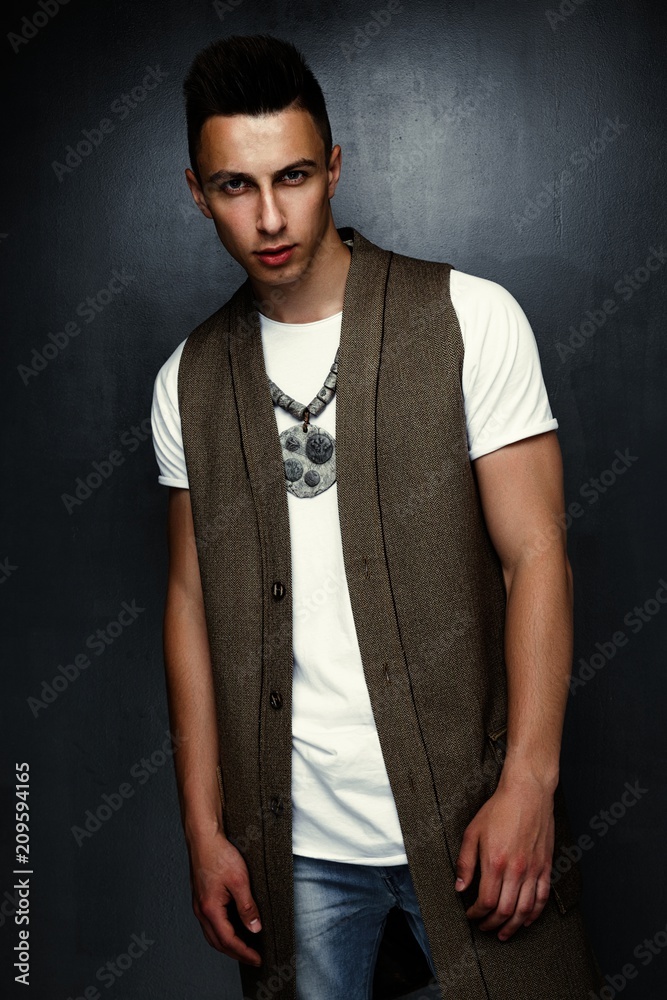 Obraz premium portrait of handsome stylish young man posing in studio