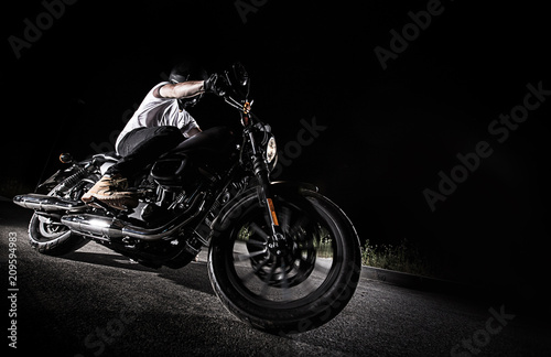 High power motorcycle chopper at night.