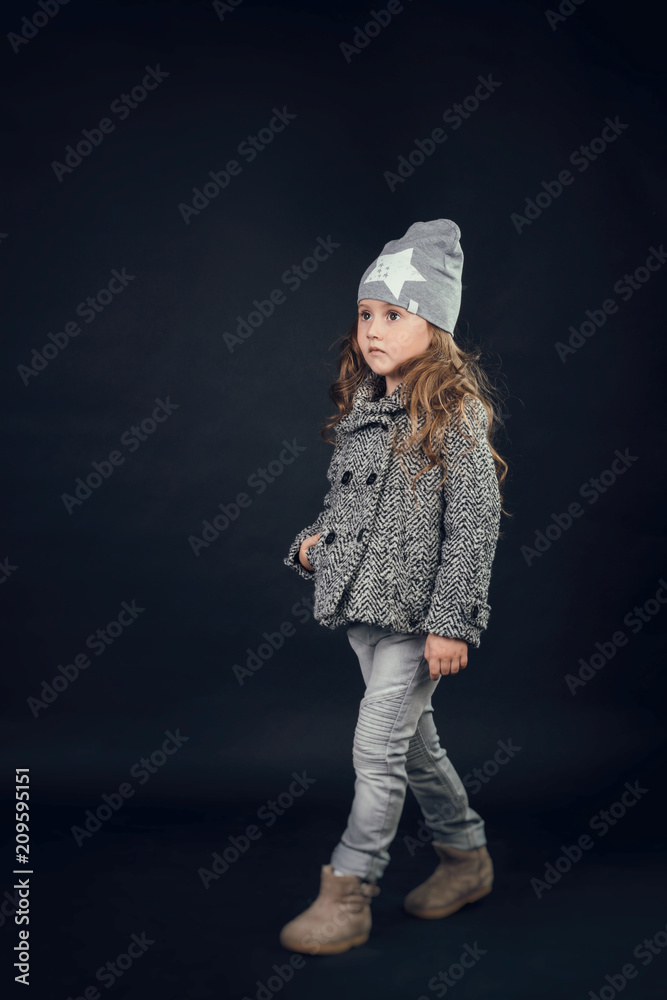 child in the Studio posing in fashionable clothes child in the Studio posing in fashionable clothes