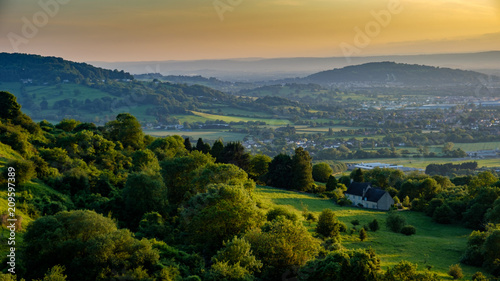 A golden sunset in summer overlooking the countryside from  Crickley hill near Gloucester, Gloucestershire  UK  photo