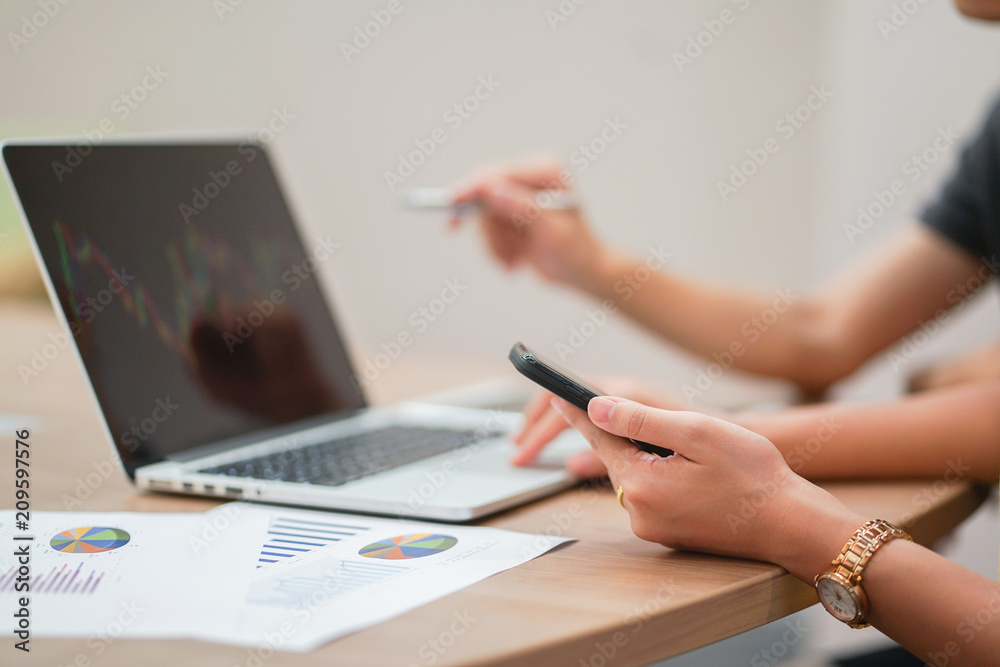 close up business woman using smartphone for checking market with investor partner for think about graph close up business woman using smartphone for checking market with investor partner for think about graph