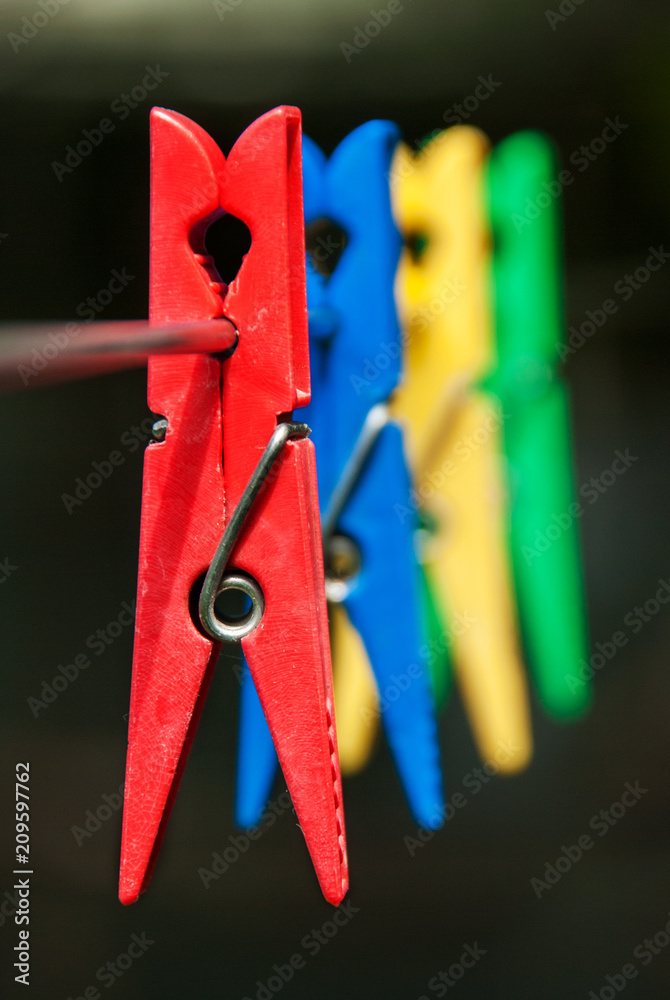 Colorful plastic clothespins on a rope