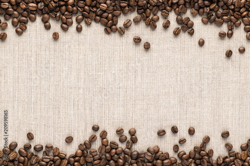 Roasted coofee seeds on canvas background. top view with space for text