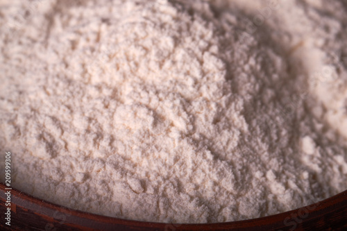 Flour spread out on wooden table seen from above. Cooking baking concept. photo