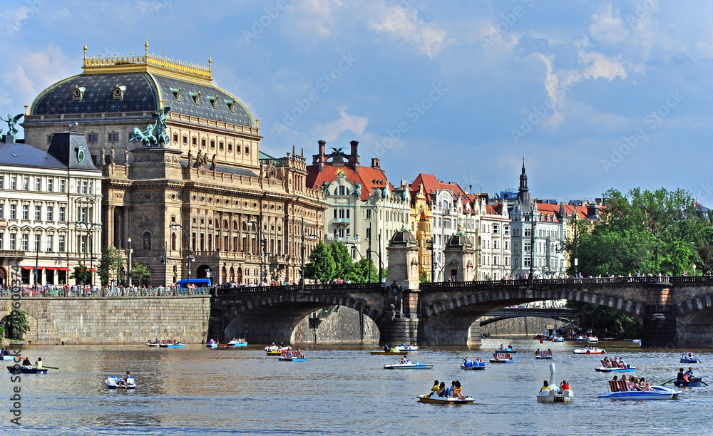Ancient National Theater with historical houses on the Vltava riverbank. Prague, Czech republic, Europe.