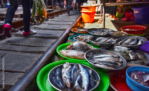 Photography Selling food on the Maeklong Railway market in Thailand