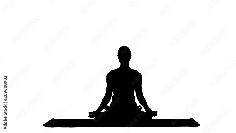 Young woman meditates while practicing yoga track matte