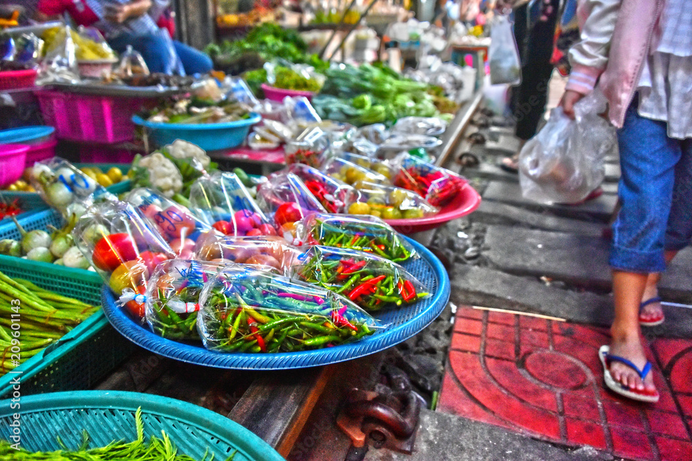 Selling food on the Maeklong Railway market in Thailand