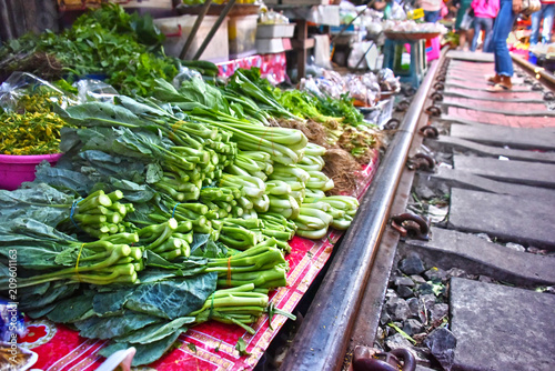 Selling food on the Maeklong Railway market in Thailand photo