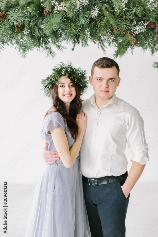 Portrait of a happy couple laughing at camera. Bridesmaid and groomsmen outdoor portrait. Funny wedding moment.