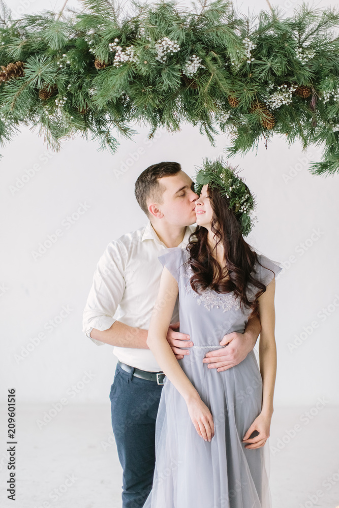 Portrait of a happy couple laughing at camera. Bridesmaid and groomsman kissing