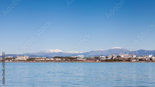 Fototapeta Naklejka Na Ścianę i Meble -  Side West Beach.  The view towards the west beach of Side taken from the peninsula of the ancient Greek city of Side in southern Turkey.