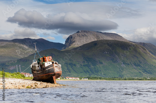 Ben Nevis.  The view across Loch Linnhe beyond an abandoned boat towards Ben Nevis, the highest mountain in Great Britain. photo