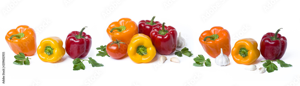 Red yellow and orange peppers on a white background..Multicolored vegetables in a composition on an abel background. Red yellow and orange peppers on a white background..Multicolored vegetables in a composition on an abel background.