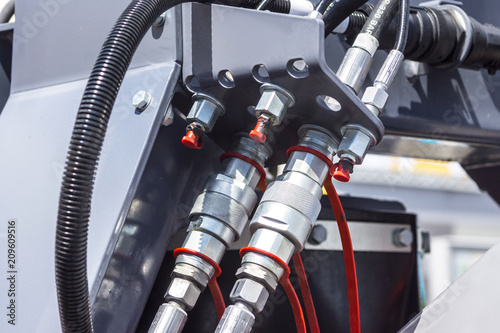 Close up of pipe system of hydraulic valves in agricultural machinery