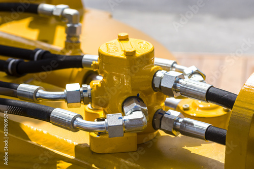 Close up of pipe system of hydraulic valves in agricultural machinery