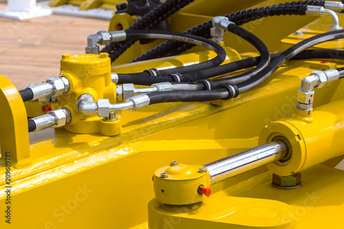 Close up of pipe system of hydraulic valves in agricultural machinery