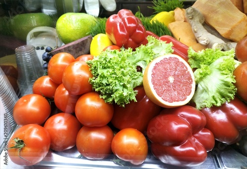  Showcase with vegetables and fruits in a supermarket and a hypermarket. Vegetables and fruits lie on a plate in the store