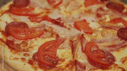 Chef cuts pizzas on counter in kitchen photo