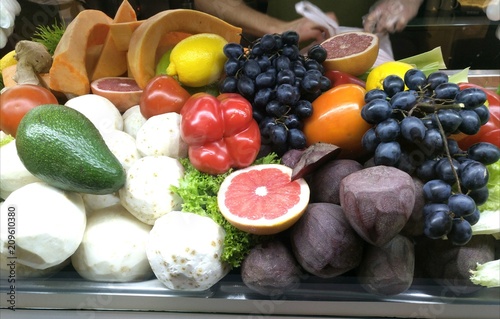  Showcase with vegetables and fruits in a supermarket and a hypermarket. Vegetables and fruits lie on a plate in the store