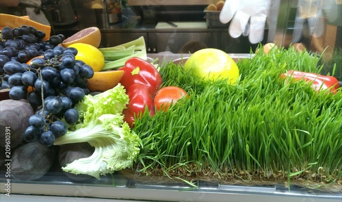  Showcase with vegetables and fruits in a supermarket and a hypermarket. Vegetables and fruits lie on a plate in the store