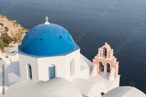 Details of a traditional Orthodox blue dome in Greece on a very sunny summer day, with the typical blue and white colours. Santorini, Cyclades Islands, Greece, Europe
