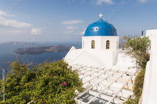 Traditional Orthodox blue dome church in Greece on a sunny summer day, with the typical blue and white colours. Santorini, Cyclades Islands, Greece, Europe