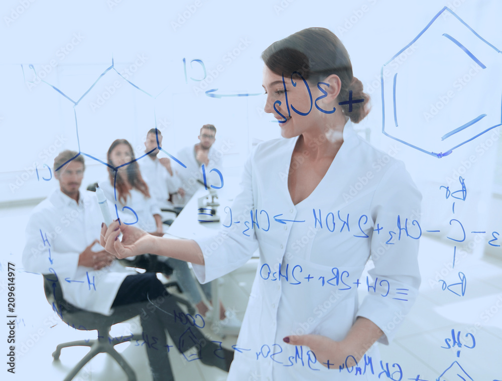 © ASDF - view through the transparent Board. female biochemist analyzing information. © ASDF - view through the transparent Board. female biochemist analyzing information.