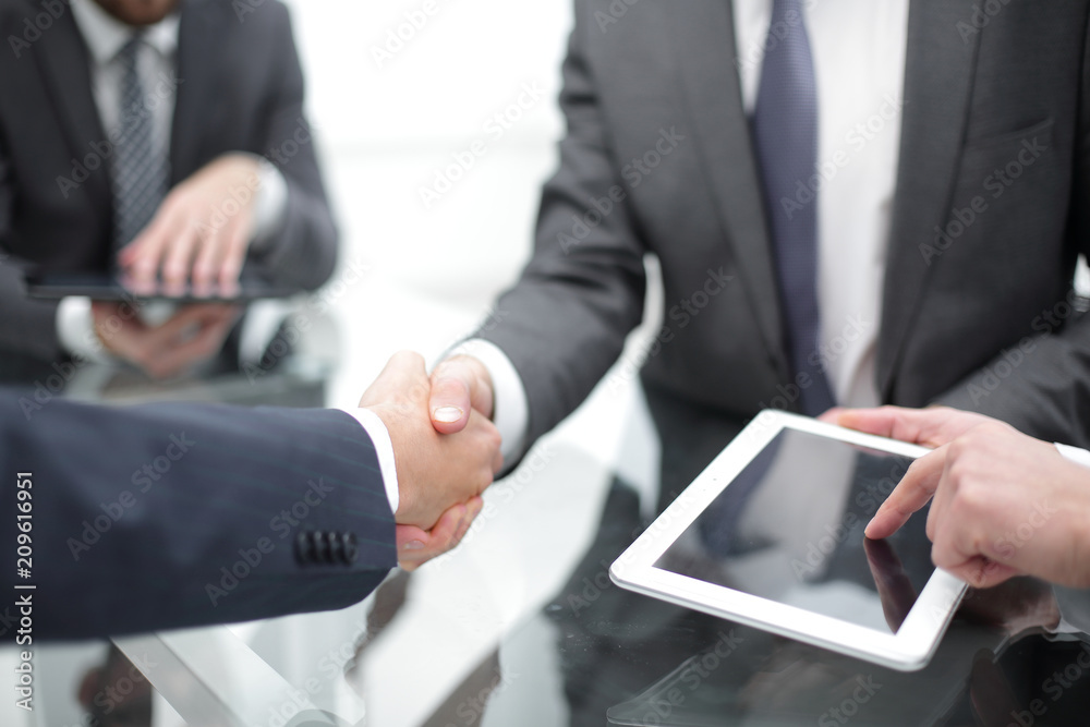 Men shaking hands with smile at office with their coworkers. Men shaking hands with smile at office with their coworkers.