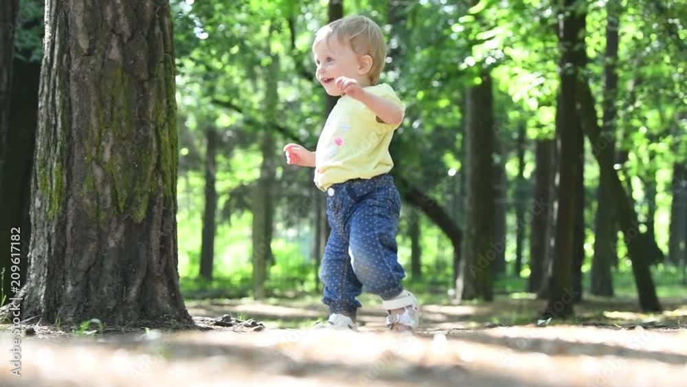 first steps. female baby toddler learns to walk first steps. female baby toddler learns to walk
