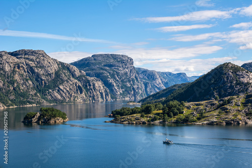Fantastic nature landscape view of the fjord, mountains and sailing vessel. Location: Lysefjorden, Scandinavian Mountains, Norway, Europe. Artistic picture. Beauty world.