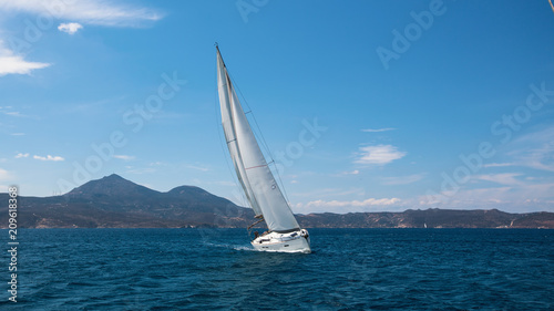 Sailing ship luxury yacht with white sails in the Mediterranean sea.