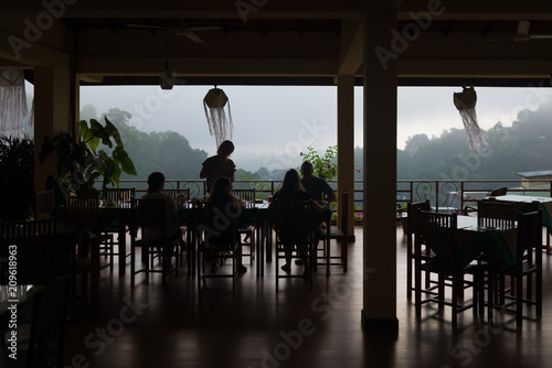  View of   terrace, silhouette people eat at the table © Аrtranq