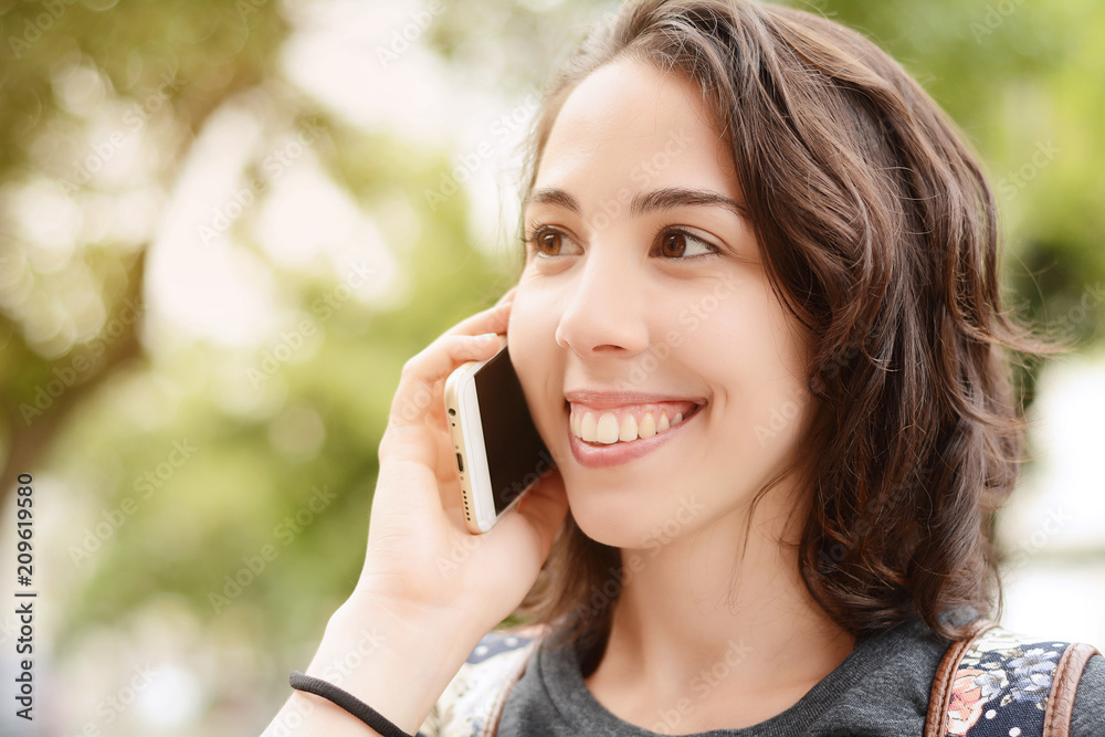 Young woman talking on her mobile phone.