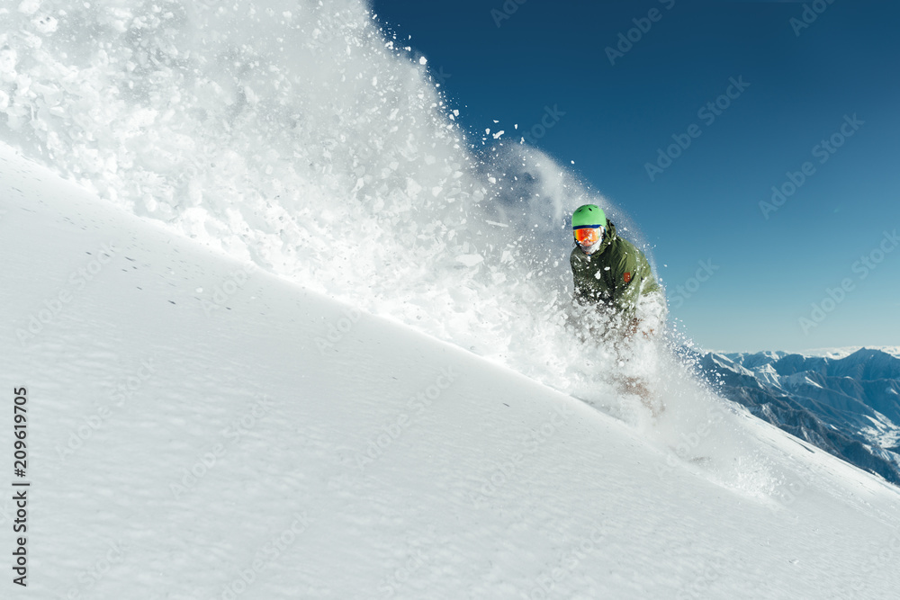 male snowboarder curved and brakes spraying loose deep snow on freeride  slope Stock Photo | Adobe Stock