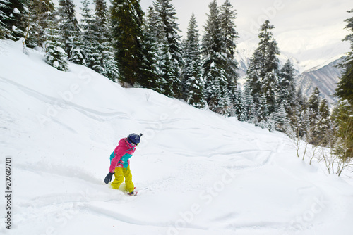 girl snowboarder rides freeride in forest