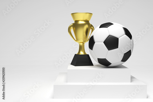 Soccer ball and a gold cup in a white studio photo