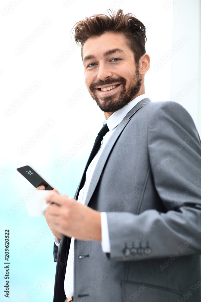 Stylish man in suit is reading information on phone Stylish man in suit is reading information on phone
