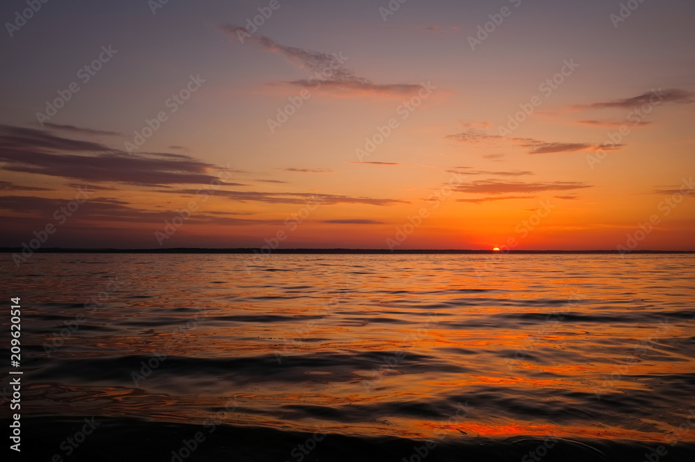 Beautiful fiery sunset sky on the beach. Composition of nature