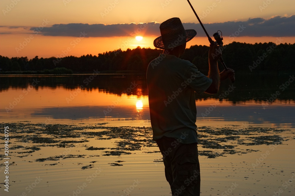 Fisherman catching the fish during sunset Fisherman catching the fish during sunset