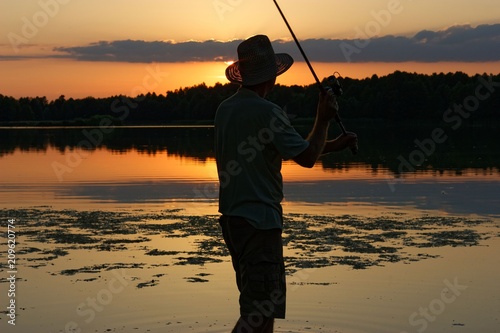 Fisherman catching the fish during sunset
