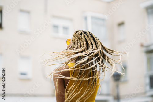 Afro-haired latin woman posing at camera.