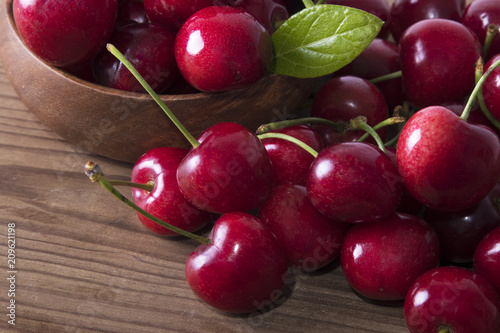 red cherries on rustic wood