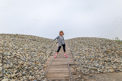 Girl dancing floss on seaside in Pembrokeshire, Wales photo