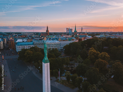 June 10, 2018. Riga, Latvia. Beautiful aerial view of the statue of liberty Milda in the center of the old town during amazing evening sunset view. photo