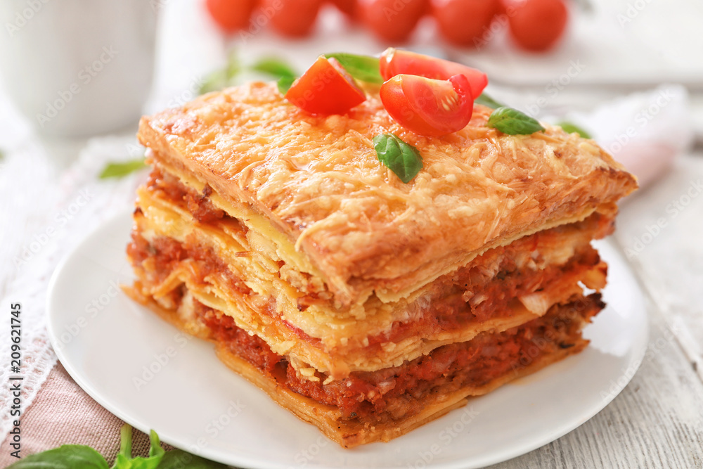 Plate with tasty lasagna on table, closeup