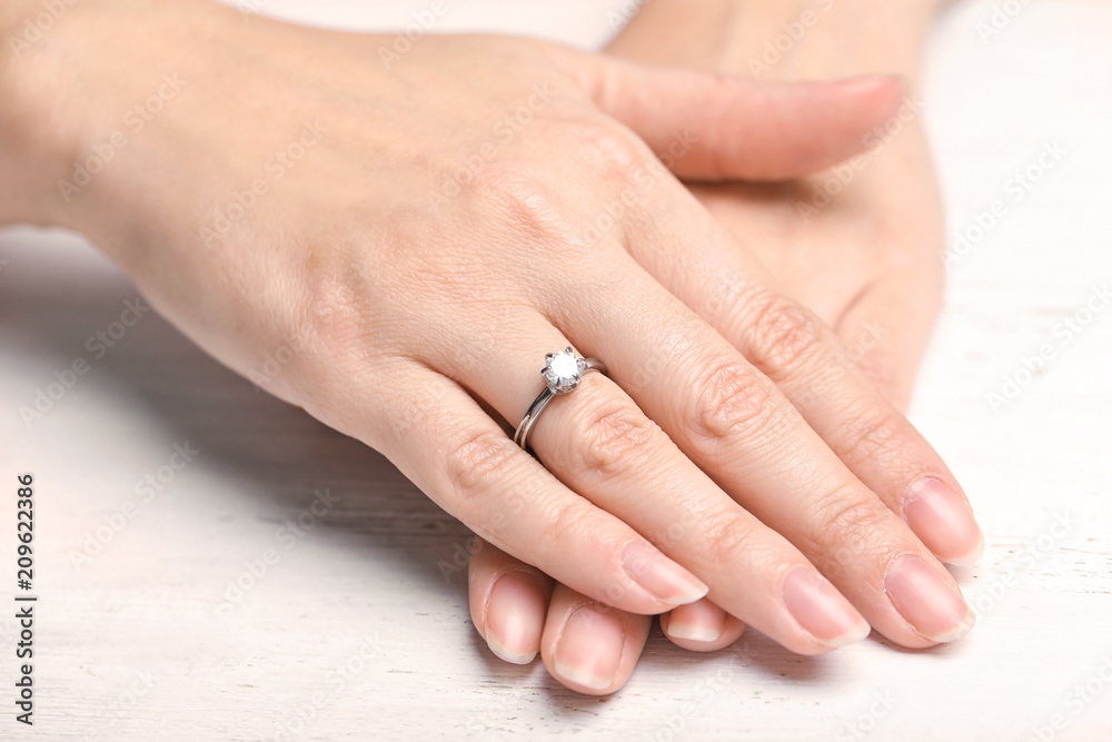 Woman wearing beautiful engagement ring, closeup Woman wearing beautiful engagement ring, closeup